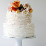 Pink, Orange and Brown Roses top this Ruffled Wedding Cake