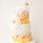 Gold Wedding Cake with Pastel Blossoms and White Peonies