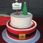 Christmas Cake tiered with Santas belt and one tier with North Pole and Christmas Tree