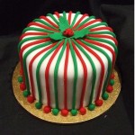 Christmas cake with red and green fondant stripes fondant balls and holly