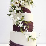 Wedding Cake with Purple Sash and Flowers